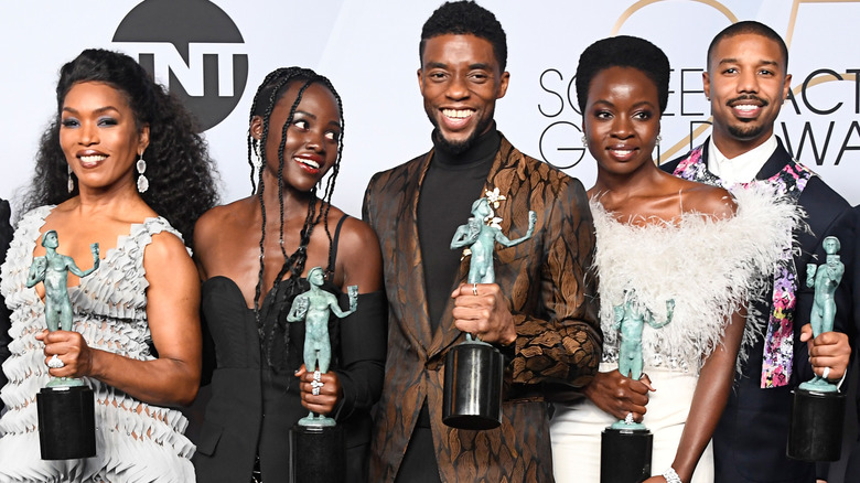 Angela Bassett, Lupita Nyong'o, Chadwick Boseman, Danai Gurira, and Michael B. Jordan smiling with their Screen Actors Guild Awards