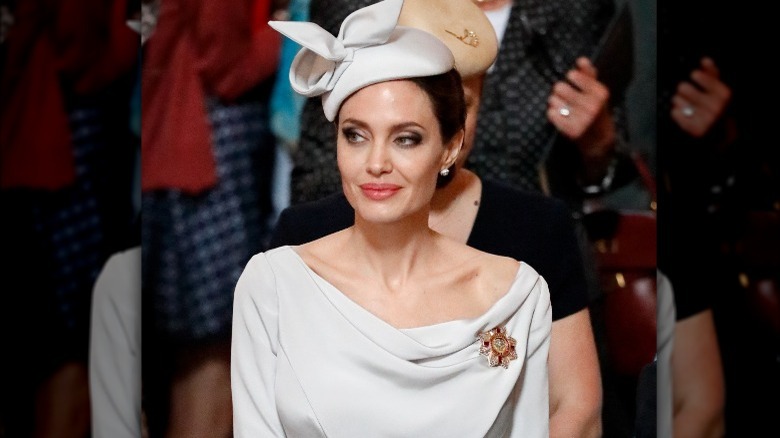 Angelina Jolie seated at an event, looking away