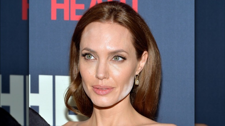 Angelina Jolie posing, with face powder on face