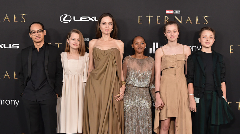 Angelina Jolie poses with her children on the red carpet