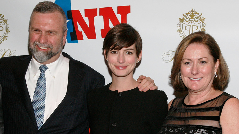 Anne Hathaway posing with her parents