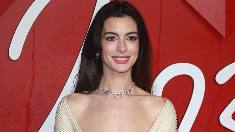 Anne Hathaway smiling on red carpet