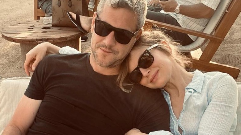 Ant Anstead and Renee Zellweger sitting outside, in sunglasses