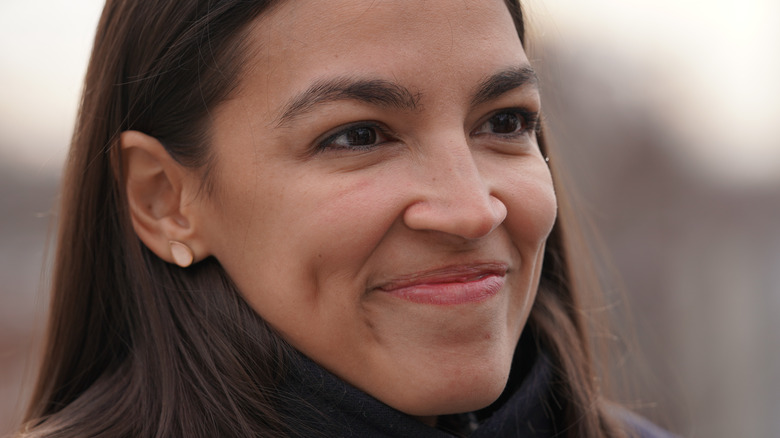 Alexandria Ocasio-Cortez smiles with hair down