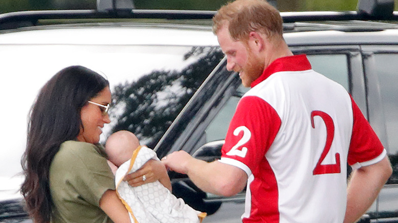 Prince Harry and Meghan Markle carrying baby Archie