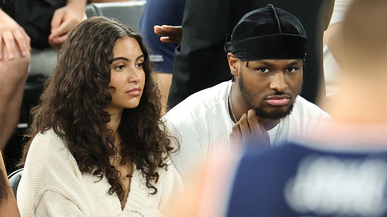 Bronny James and Parker Whitfield watching a basketball game at the Paris Olympics.