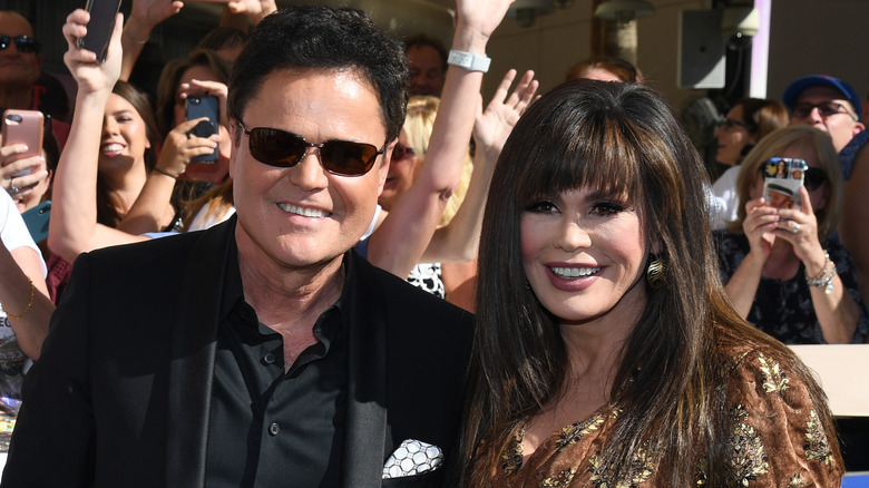 Donny and Marie Osmond posing