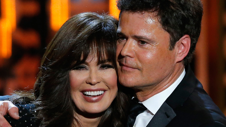 Donny and Marie Osmond cuddling sweating