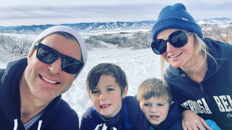 Jeff Schroeder, Jordan Lloyd, and their sons Layton and Lawson smiling in the snow