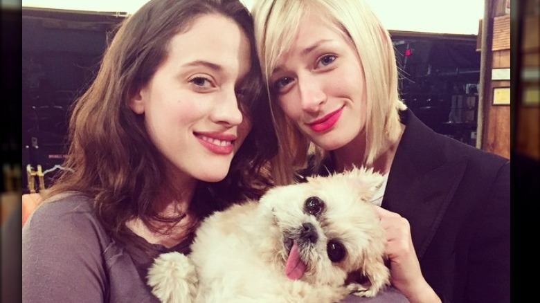 Kat Dennings, Beth Behrs holding dog