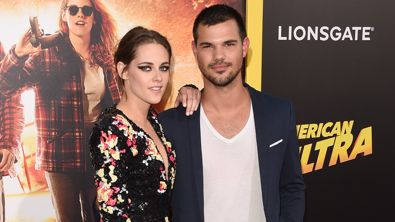 Kristen Stewart with hand on Taylor Lautner's shoulder