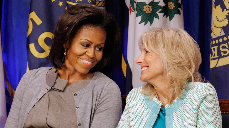 Michelle Obama and Jill Biden smile at each other