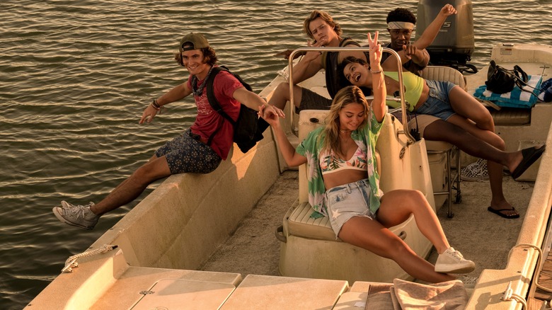 Cast of Outer Banks on boat filming