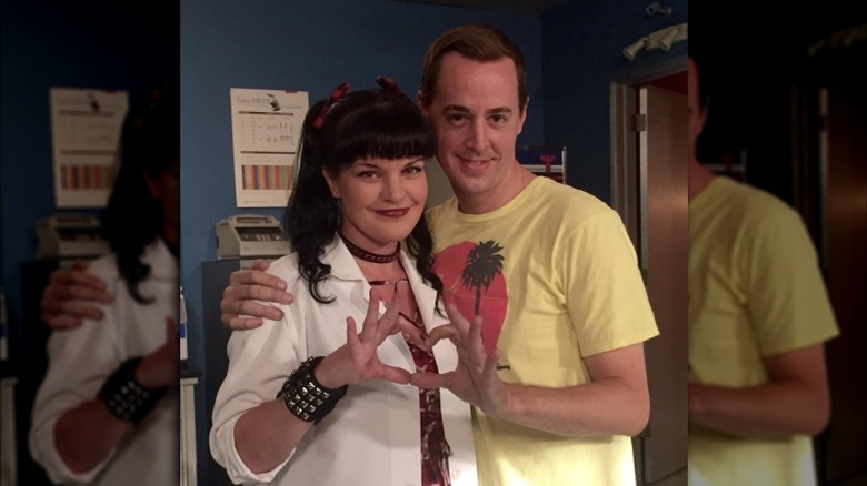 Pauley Perrette and Sean Murray form heart with hands