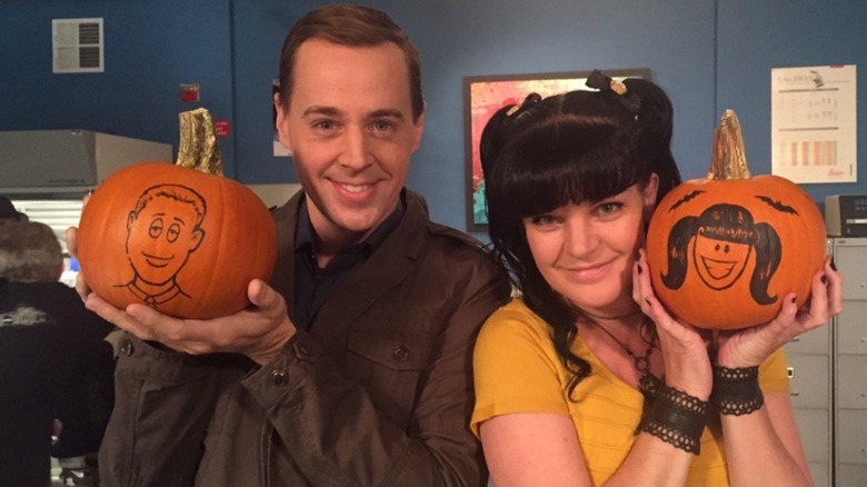 Sean Murray and Pauley Perrette holding pumpkins