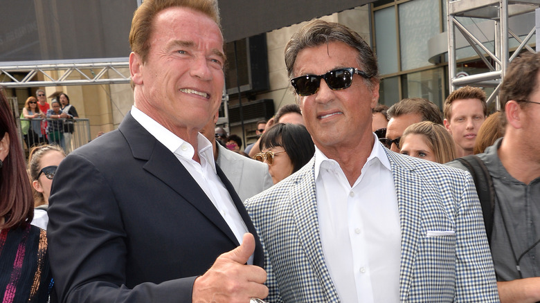 Arnold Schwarzenegger and Sylvester Stallone posing