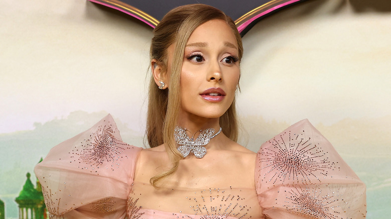 Ariana Grande with blond hair and a butterfly choker at the Australian premiere of "Wicked"