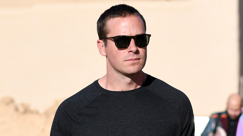 Armie Hammer walking, wearing sunglasses