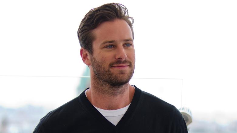 Armie Hammer looking away, smiling