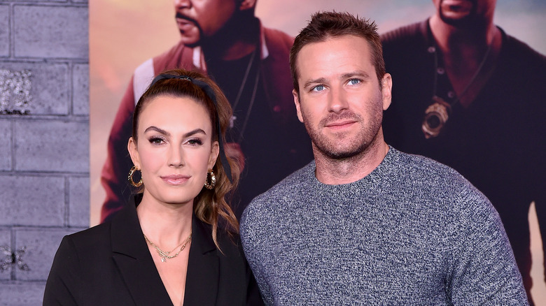 Elizabeth Chambers wearing a black blouse and Armie Hammer wearing a blue-grey sweater