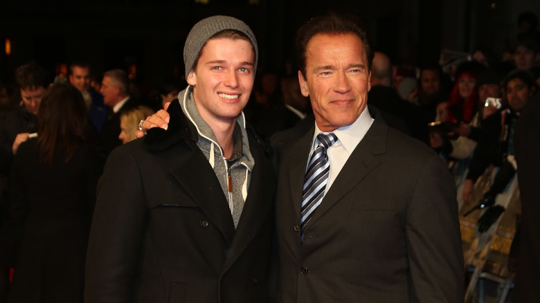 Arnold Schwarzenegger with arm around Patrick Schwarzenegger