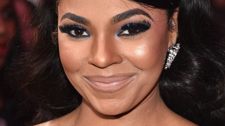 Ashanti makes a sly smile