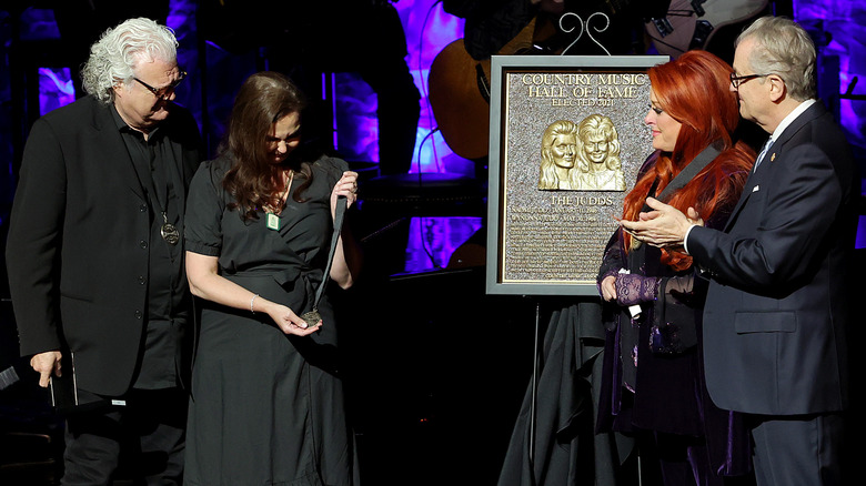 Ashley Judd (CL) accepts induction on behalf of Naomi Judd