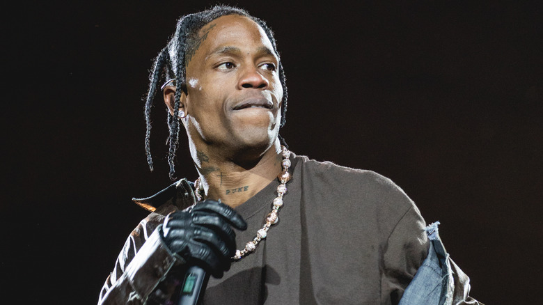 Travis scott on stage biting lip with microphone