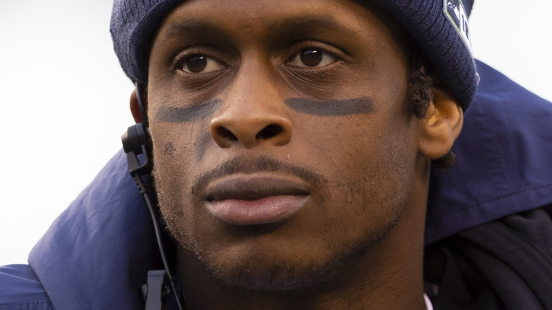 Geno Smith on the sidelines, looking away