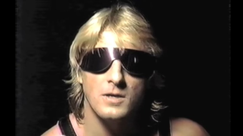 Owen Hart speaking in interview, wearing sunglasses 