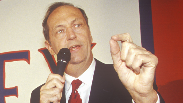 Bill Bradley holds microphone