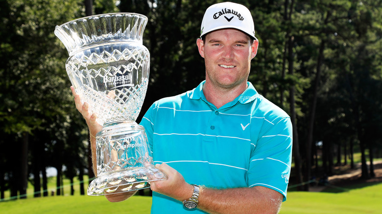 Grayson Murray holding trophy