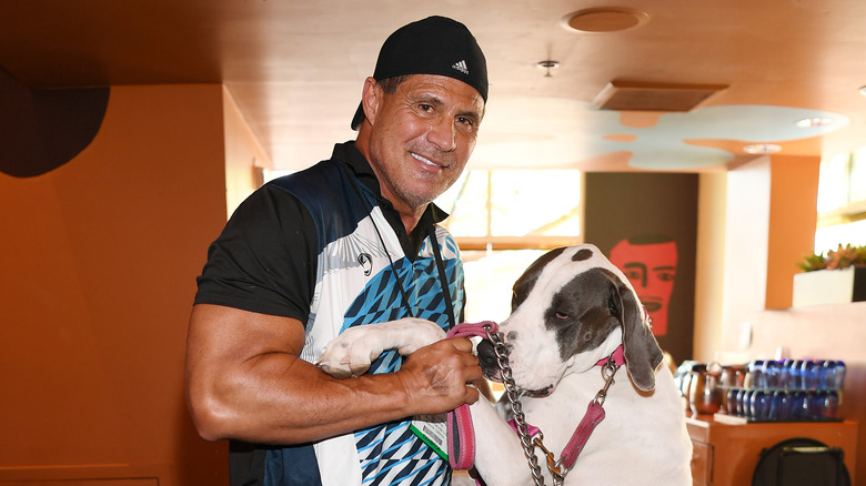 Jose Canseco posing with a dog