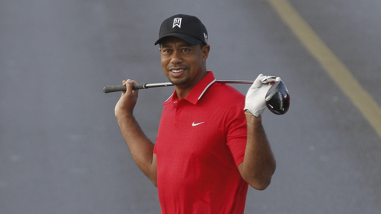 Tiger Woods posing with a golf club