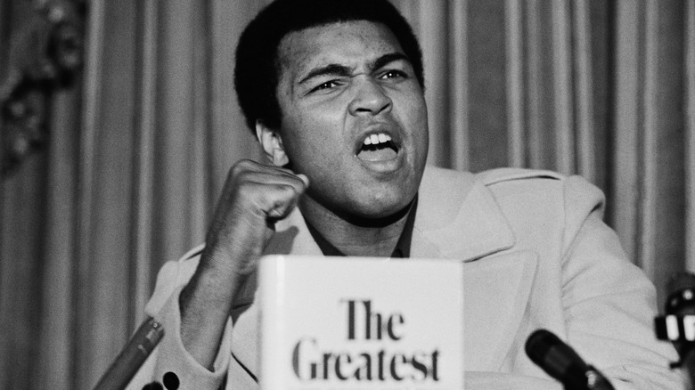 Muhammad Ali raising fist while speaking