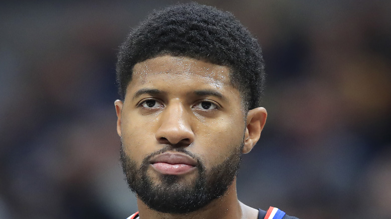 Paul George playing basketball, looking sullen