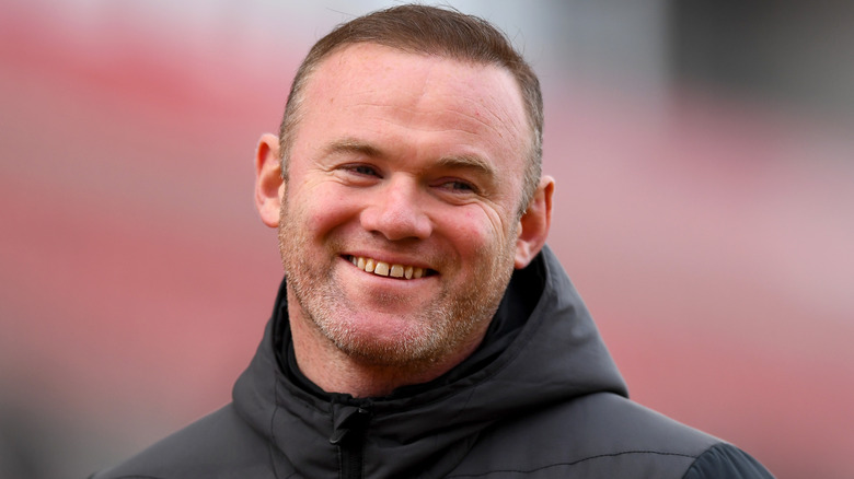 Wayne Rooney wearing jacket smiling 