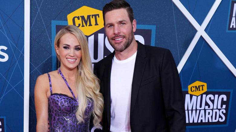 Carrie Underwood and Mike Fisher, both smiling