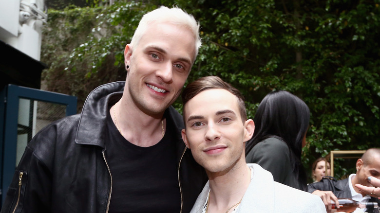 Jussi-Pekka Kajaala and Adam Rippon holding drinks