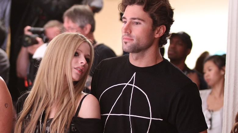 Avril Lavigne and Brody Jenner talk at an event