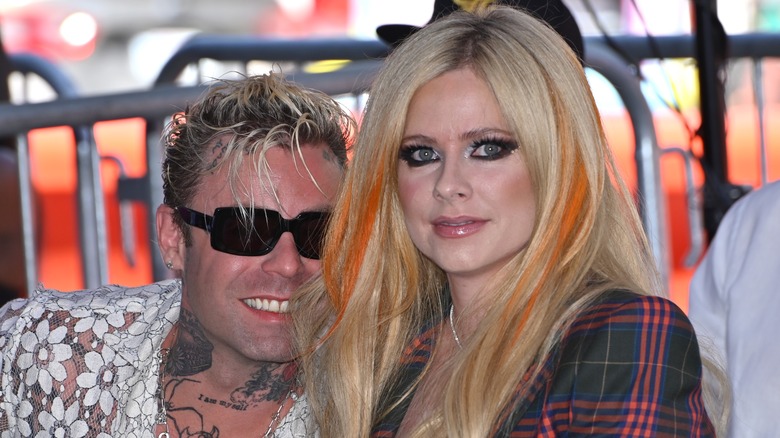 Avril Lavigne and Mod Sun sitting