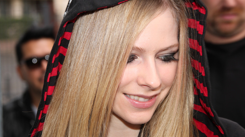 Avril Lavigne looking down, smiling