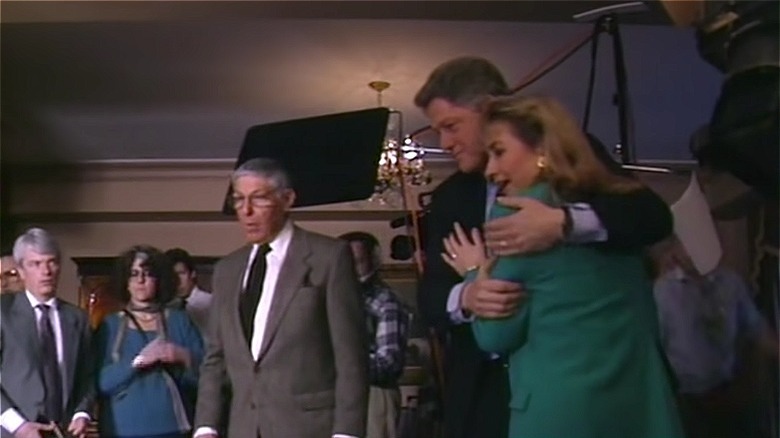 Bill Clinton hugs Hillary, surrounded by 60 Minutes producers