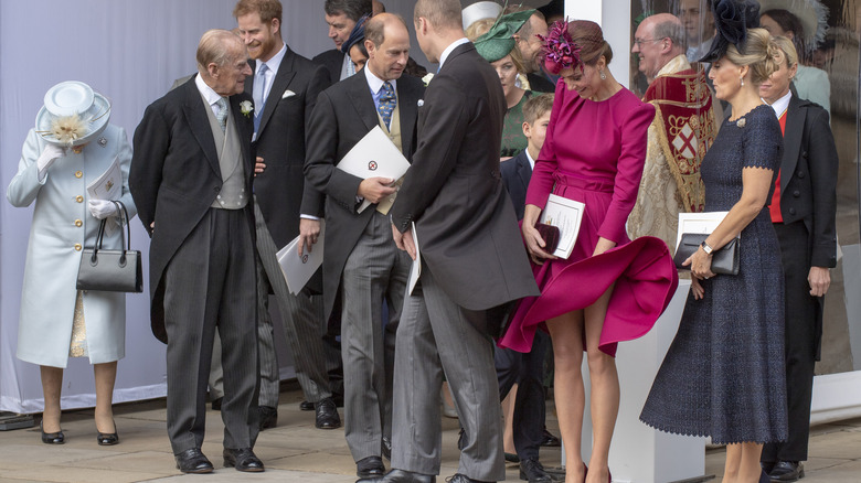 Kate Middleton pushing down her windblown dress