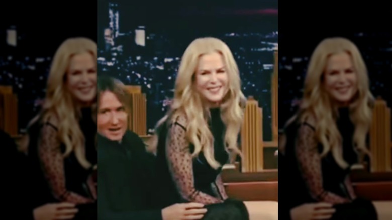 Nicole Kidman sitting on Keith Urban's lap