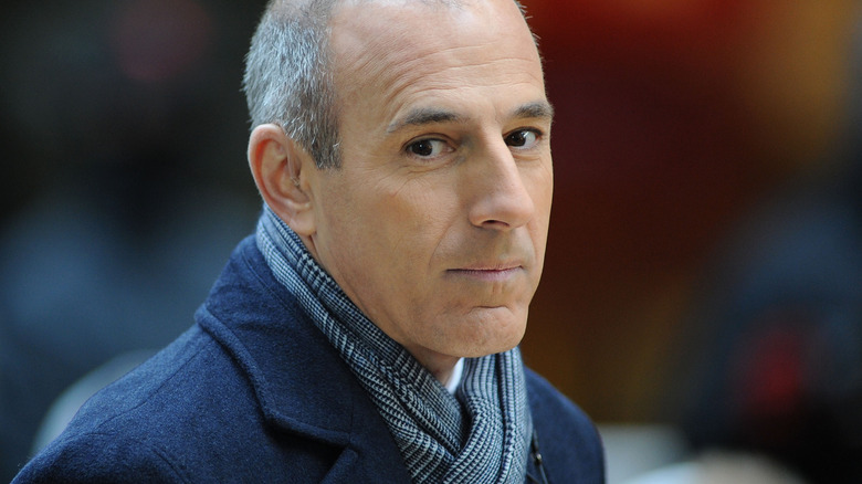 Matt Lauer wearing a scarf, walking