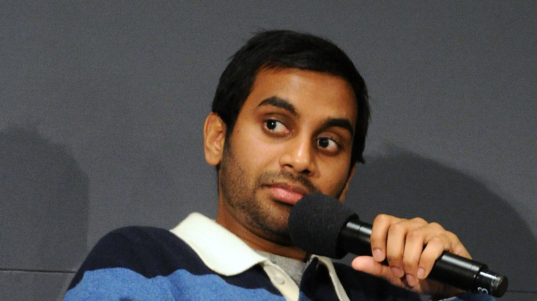 Aziz Ansari holding microphone