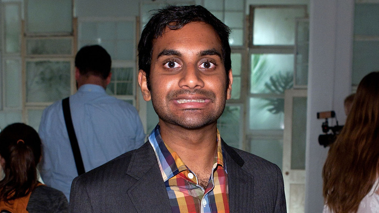 Aziz Ansari smiling with teeth