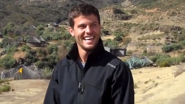 Eric Hill smiling and looking to the side in the mountains