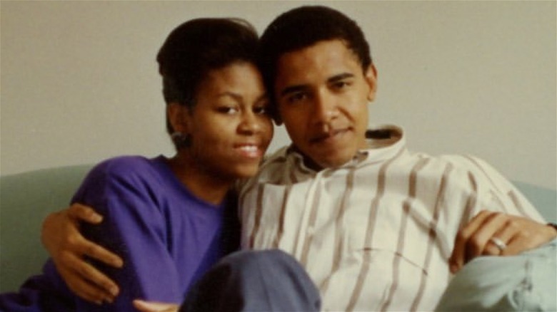 Michelle and Barack Obama posing together on couch